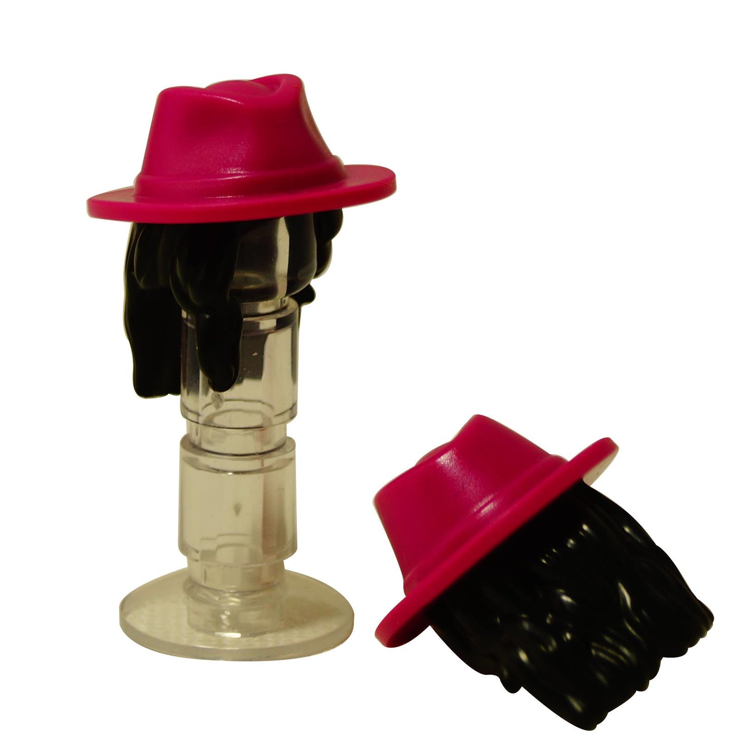Two black LEGO minifigure hairpieces with sculpted waves, one topped with a bright pink fedora hat.