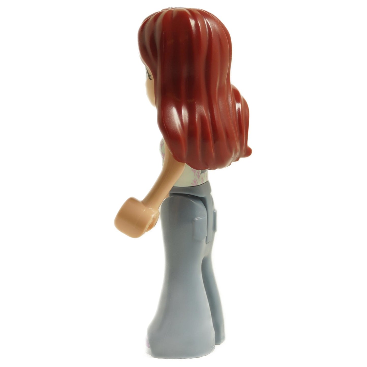 Side view of LEGO® Friends Paisley mini-doll frnd0627 with long reddish brown hair, light aqua vest, and gray flared pants