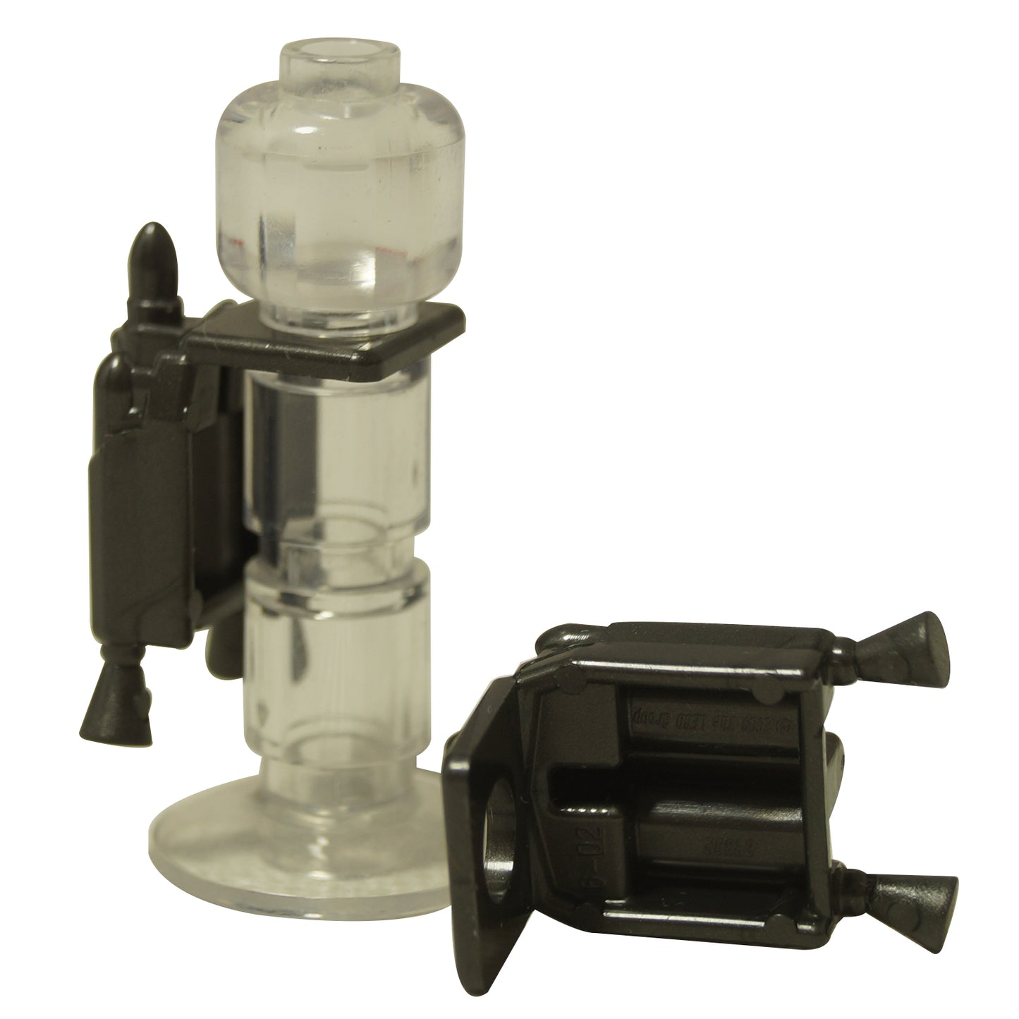 Two black LEGO jet packs with nozzles 64802, one on a clear stand.