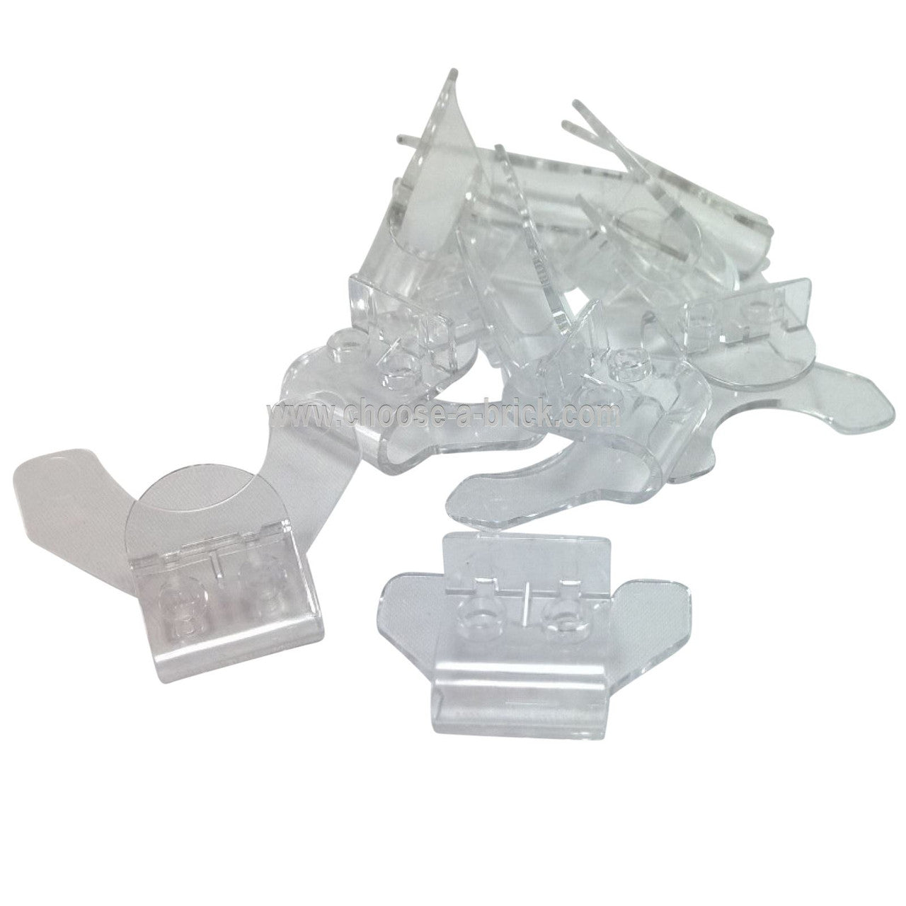 Clear transparent LEGO Minifigure Super Jumper pieces (Part 18663) in a pile, designed for dynamic minifigure action poses.