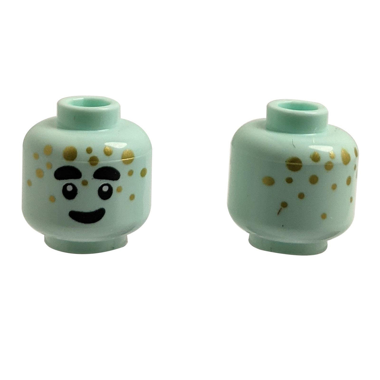 Front and back of light aqua LEGO head 3626pb3437 with alien face and gold dots.