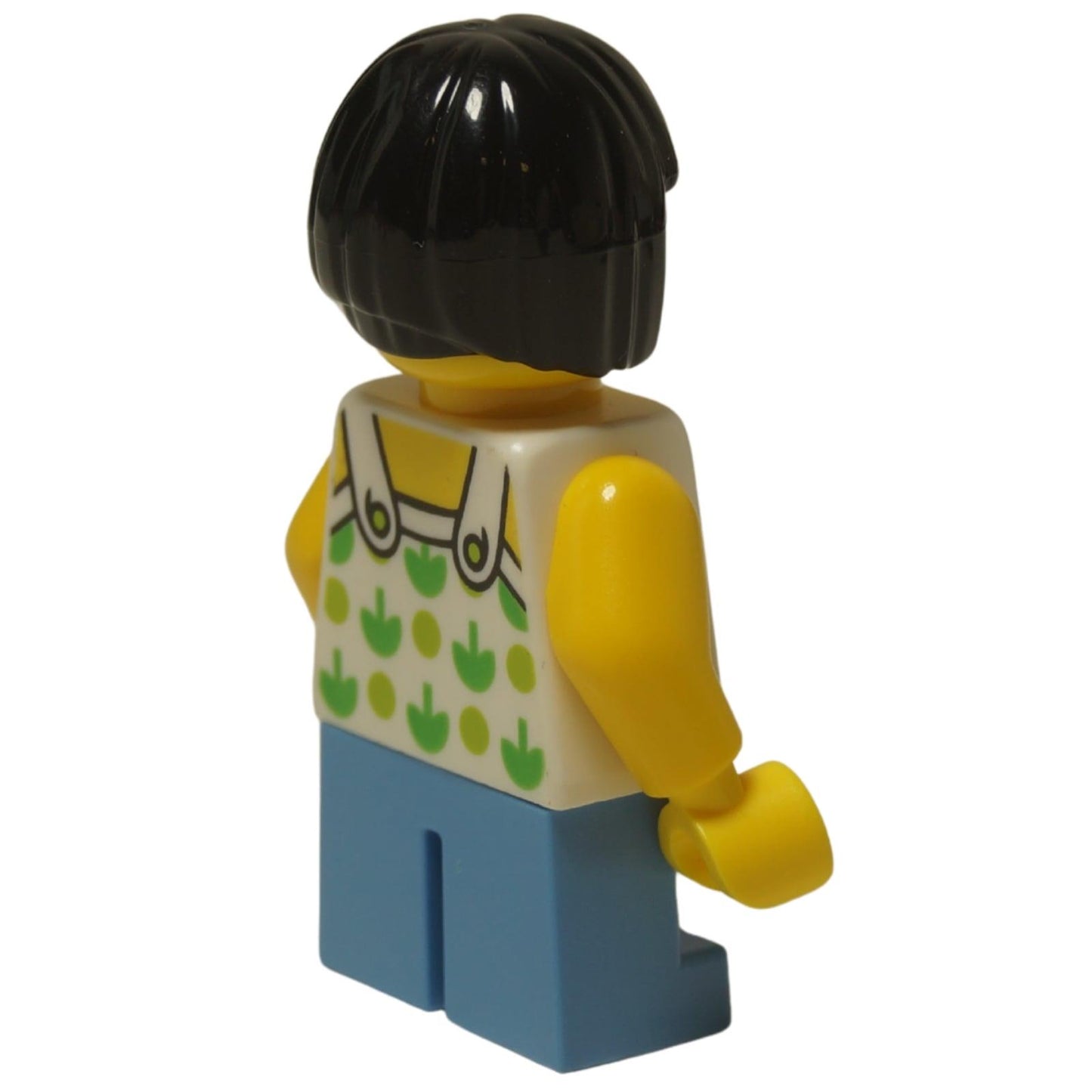 LEGO City child girl minifigure twn322 with green apple shirt and short legs. Side pprofile view.