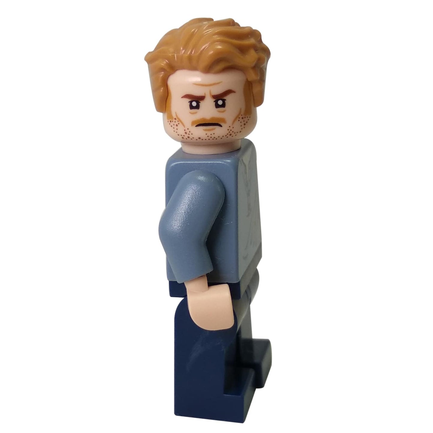 LEGO® Owen Grady minifigure side view, tousled hair, light blue shirt, and dark blue legs from Jurassic World