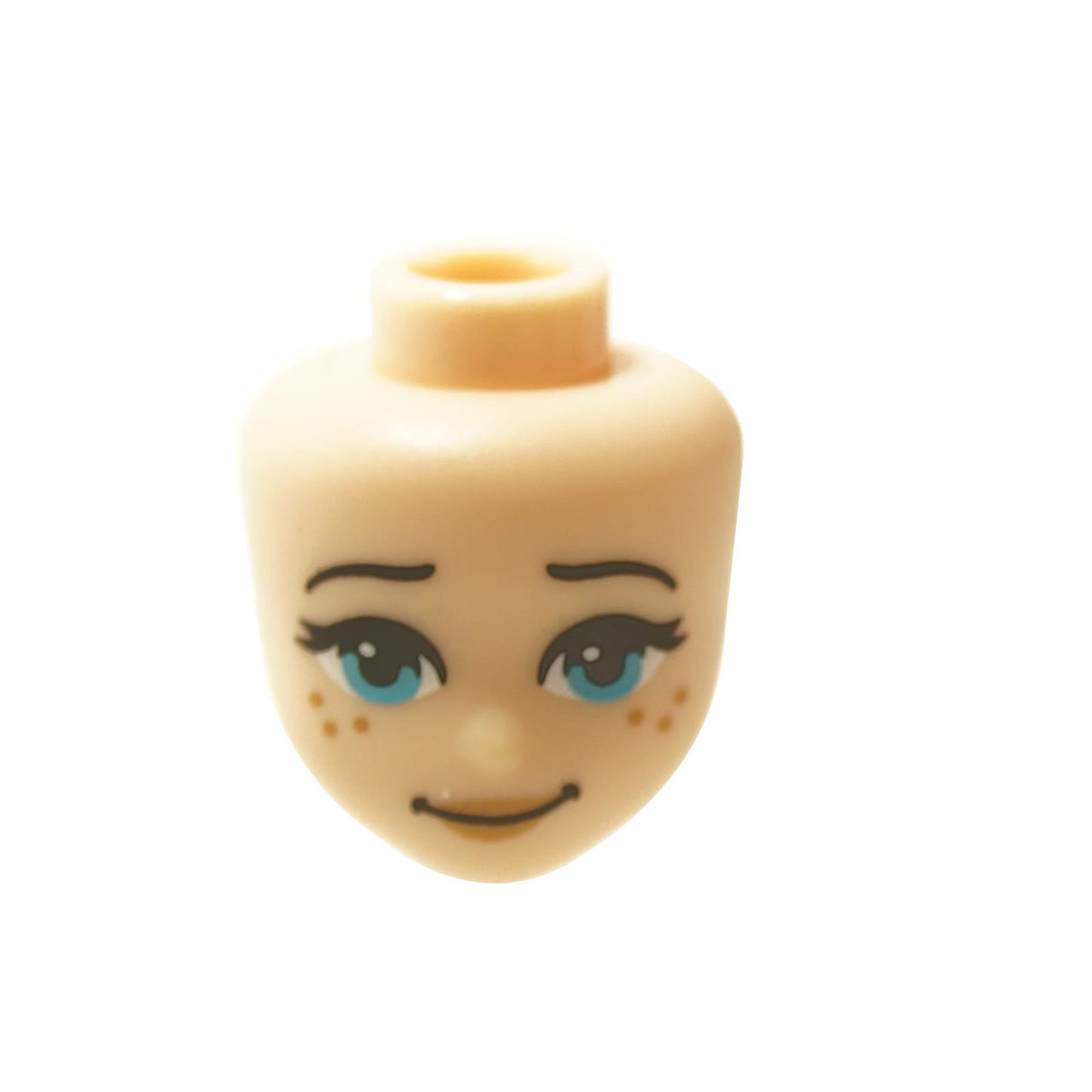 A light nougat mini-doll head with expressive blue eyes, freckles, and a slightly crooked smile.