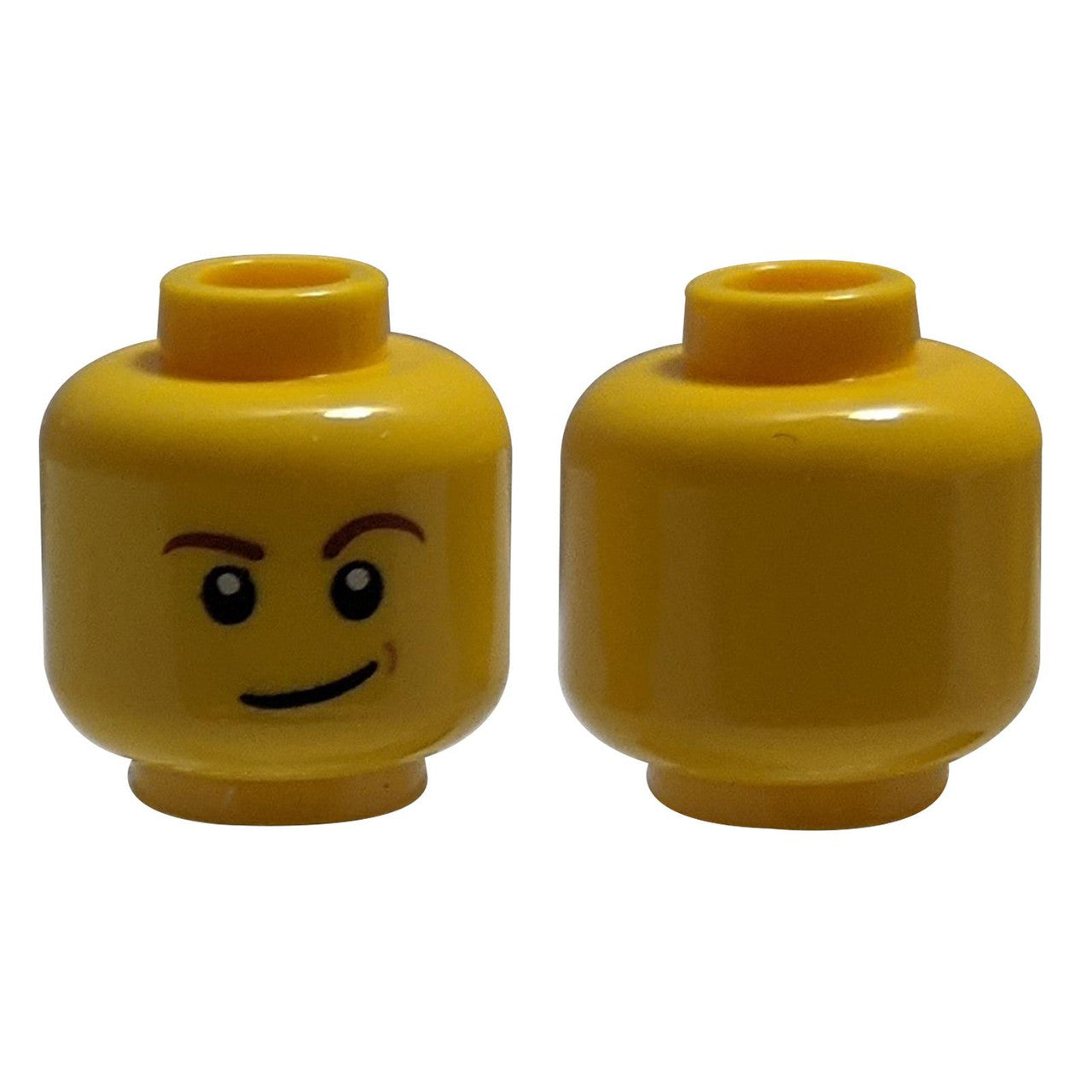 LEGO® Minifigure Head (3626pb1286) with reddish-brown eyebrows, a lopsided smile, and a nougat-colored dimple.