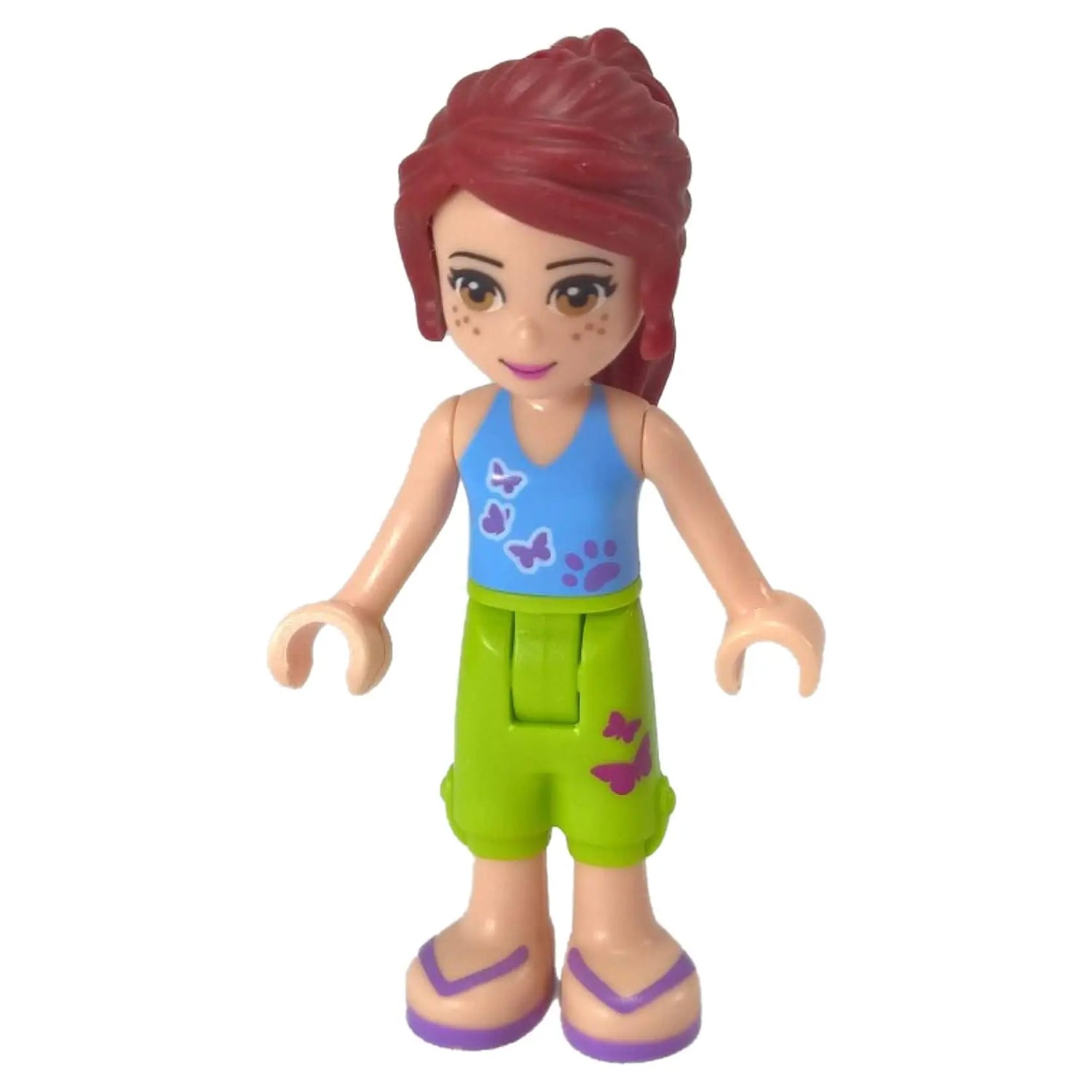 LEGO Friends Mia mini-doll with red hair, freckles, blue butterfly tank top, and lime green shorts.