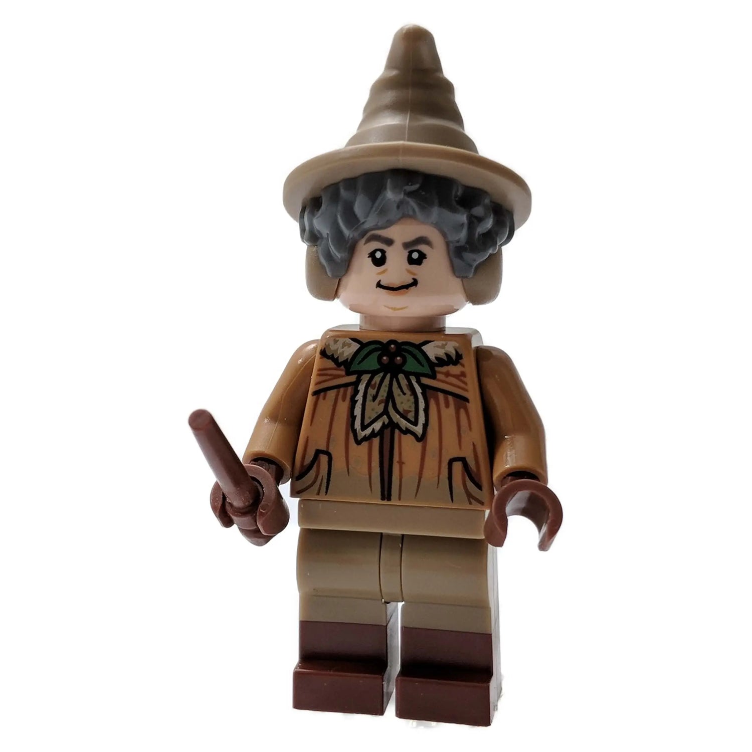 LEGO Professor Pomona Sprout minifigure with tan robes, a wand, and a pointed hat shaped like a Mandrake leaf, based on her appearance from the Harry Potter series.