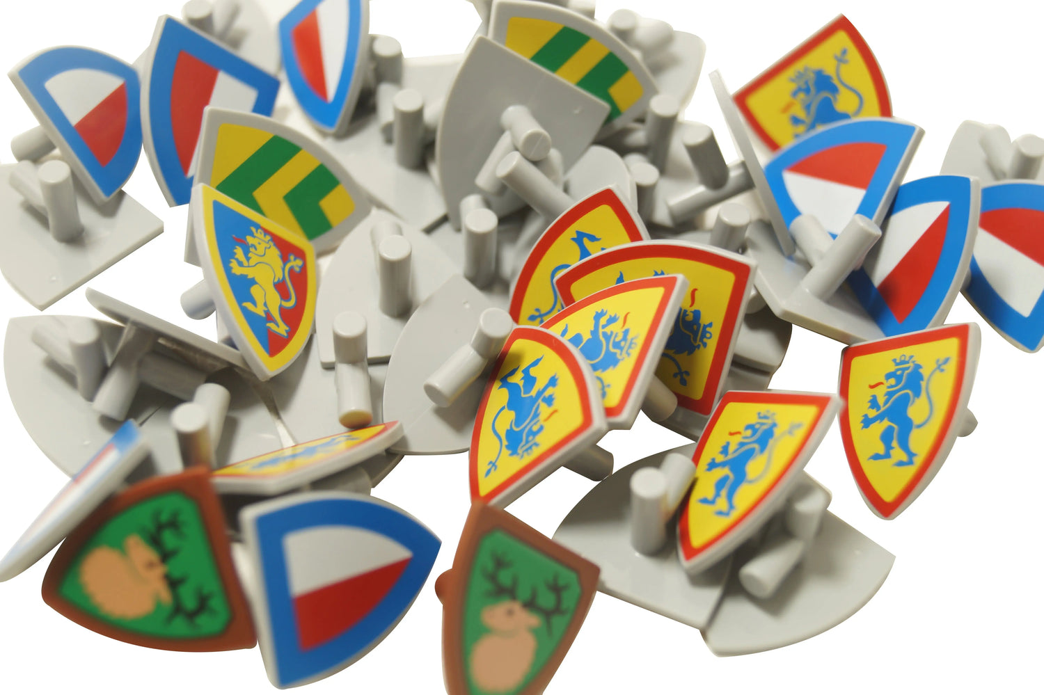 Assorted LEGO® minifigure shields with medieval-style prints, including lions, deer, and classic heraldic patterns on triangular and kite-shaped shield elements.