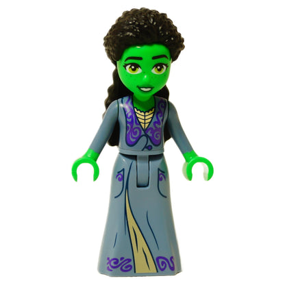 Front view of the LEGO® Elphaba mini-doll (wck004) featuring green skin, dark curly hair, and a sand blue dress with purple swirl patterns and gold trim.