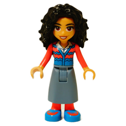 Front view of the LEGO® Nessarose mini-doll (wck002) featuring dark curly hair, blue and red patterned top, gray skirt, and blue shoes with red details.