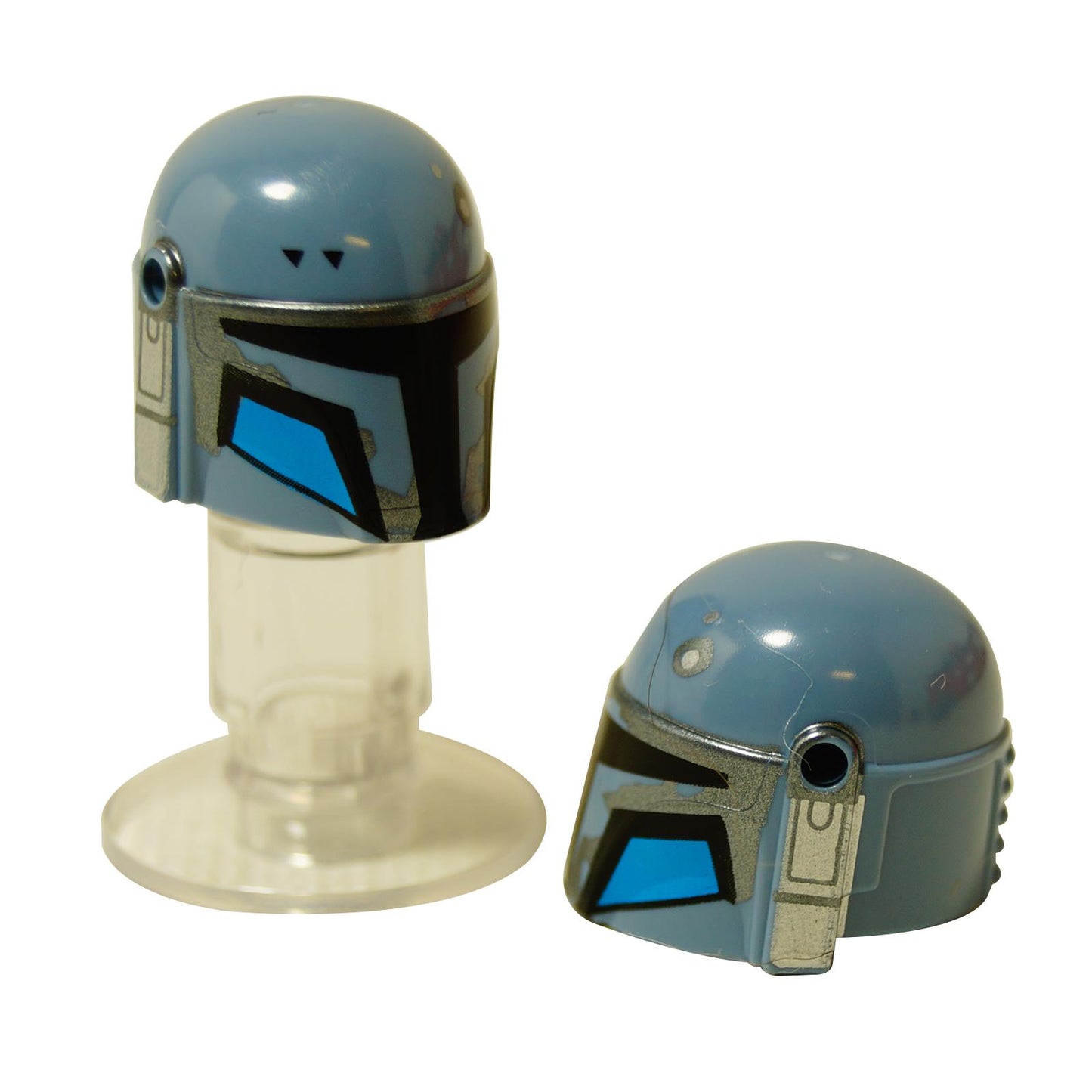 Two dusty blue LEGO Mandalorian helmets (87610pb26) with silver weathering and bright blue visor sections.