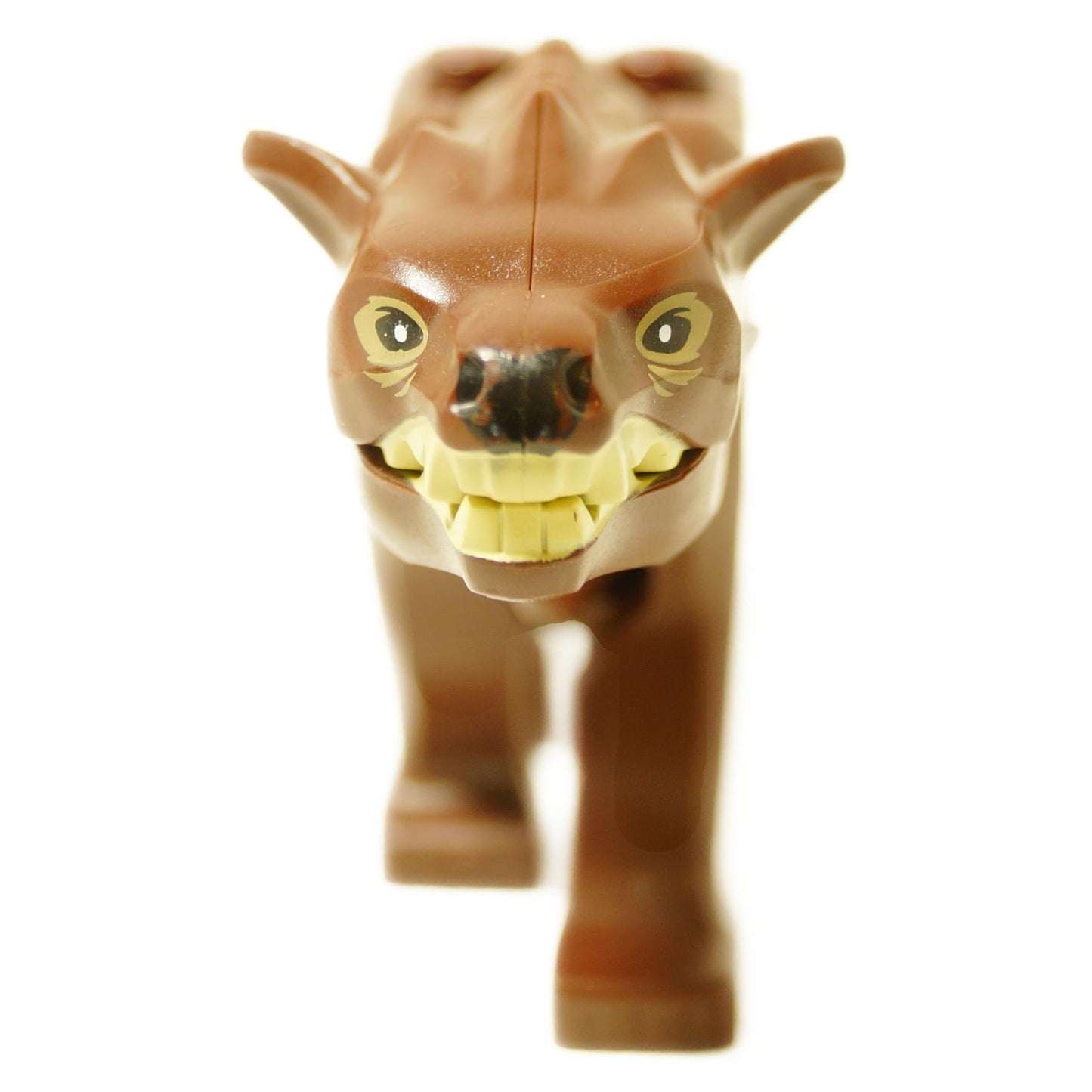 Front close-up of the LEGO Warg figure showing its snarling face, yellow eyes, and large yellow fangs.