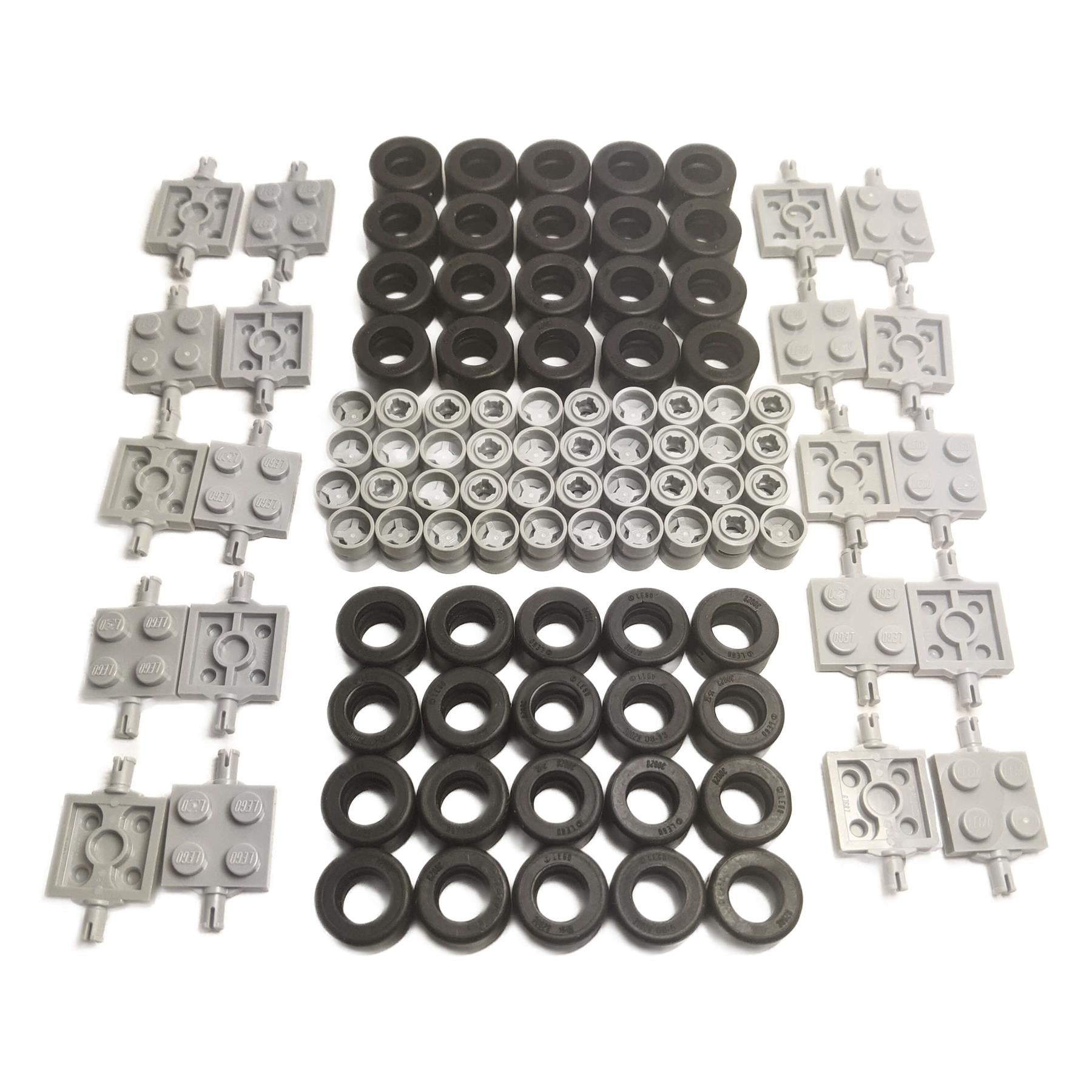 Large collection of LEGO wheel parts: black studded tires, light gray and black rims, and various light gray axle/connector plates.