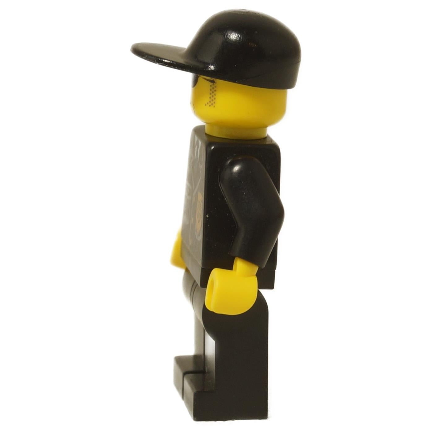 LEGO City Police Officer minifigure (cty0106) wearing a black suit, black cap, and sunglasses with a stubble beard print. Side view.