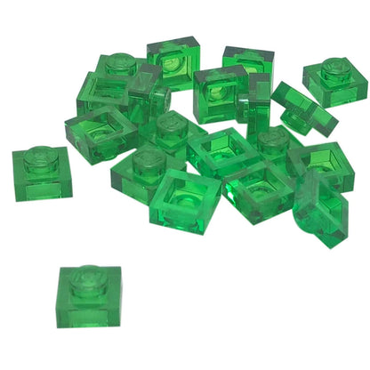 LEGO® Placa 1x1 en verde translúcido, un elemento básico versátil ideal para detalles, separación y conexiones precisas de MOC.

