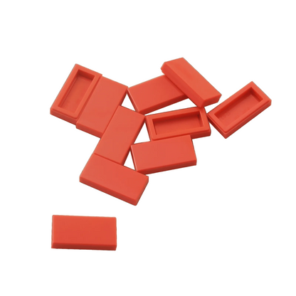 LEGO Tile 1 x 2 part 3069 with smooth rectangular top and recessed underside coral