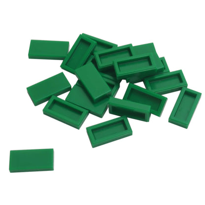 LEGO Tile 1 x 2 part 3069 with smooth rectangular top and recessed underside green