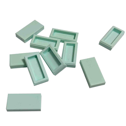 LEGO Tile 1 x 2 part 3069 with smooth rectangular top and recessed underside light aqua
