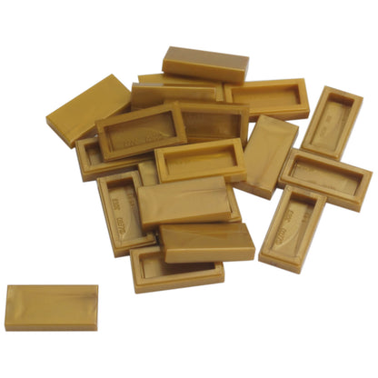 LEGO Tile 1 x 2 part 3069 with smooth rectangular top and recessed underside pearl gold