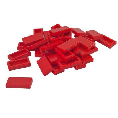 LEGO Tile 1 x 2 part 3069 with smooth rectangular top and recessed underside red