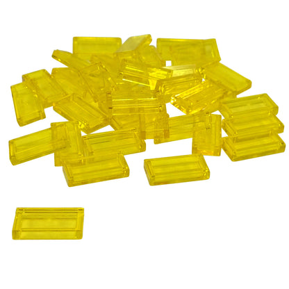 LEGO Tile 1 x 2 part 3069 with smooth rectangular top and recessed underside trans-yellow