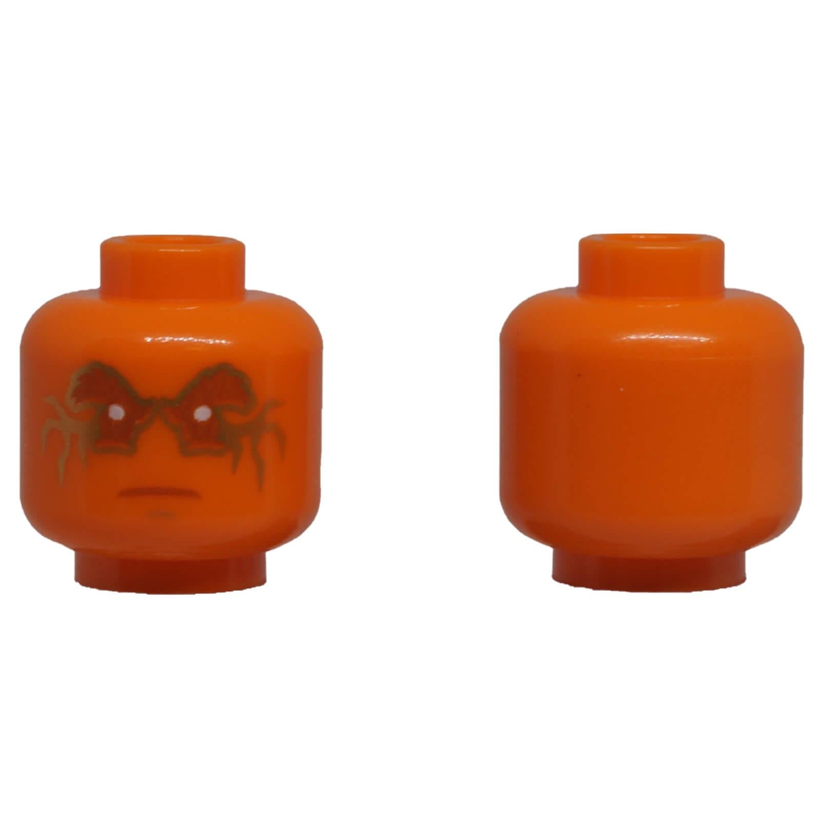 LEGO® orange minifigure head with metallic gold fracture markings, white eyes and focused facial expression.