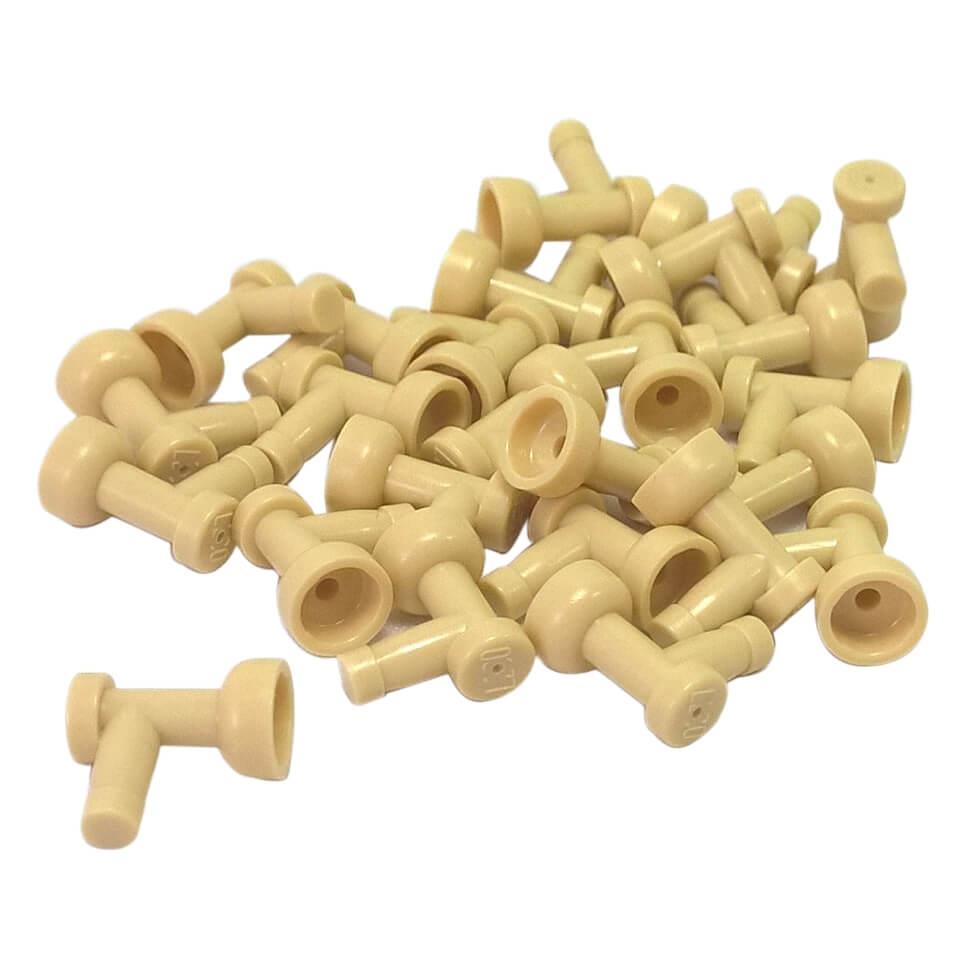 A pile of numerous tan LEGO Part 4599b (Tap 1 x 1 without Hole in End) pieces scattered against a white background, showing their T-shape with a flared cup end.