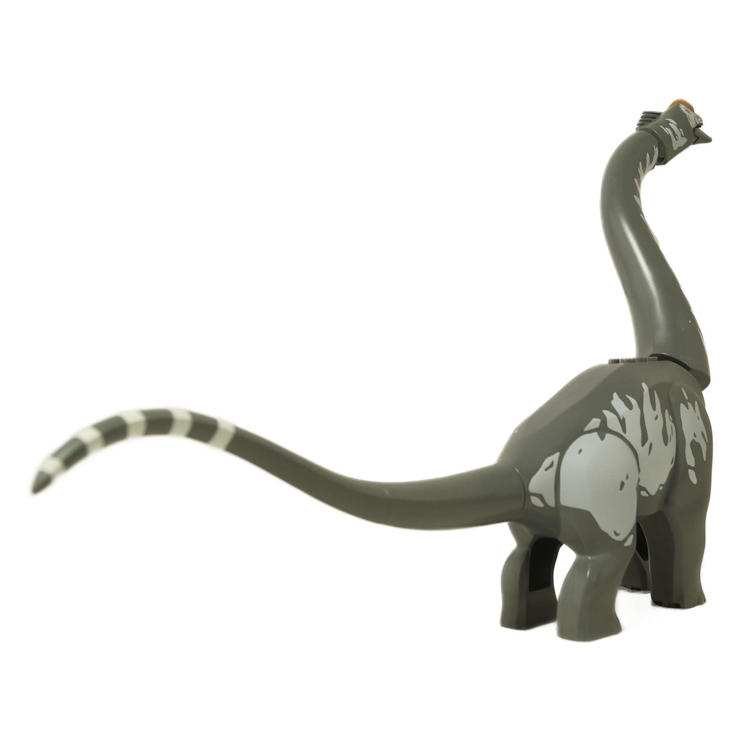 Side view of LEGO Titanosaurus showing its long neck, which has an orange nose stud attached.