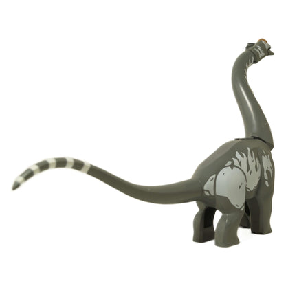 Side view of LEGO Titanosaurus showing its long neck, which has an orange nose stud attached.