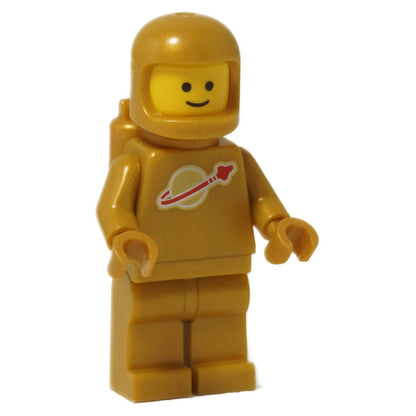 Front view of LEGO Classic Space minifigure in pearl gold, smiling, with rocket logo on chest.