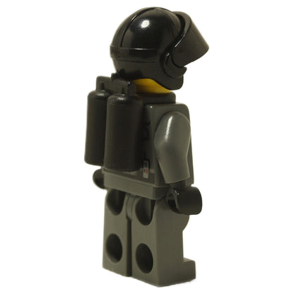 LEGO® Space Police III Officer 5 minifigure (sp099) rear view showing black dual air tanks and helmet, with printed back and leg details. Displayed on a white background.  
