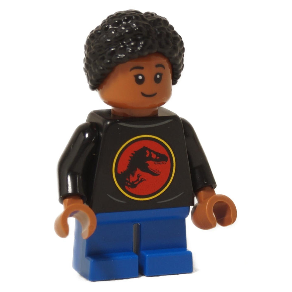 LEGO® Junior Paleontologist girl minifigure with black Jurassic Park logo shirt, blue short legs, and black braided hair, smiling
