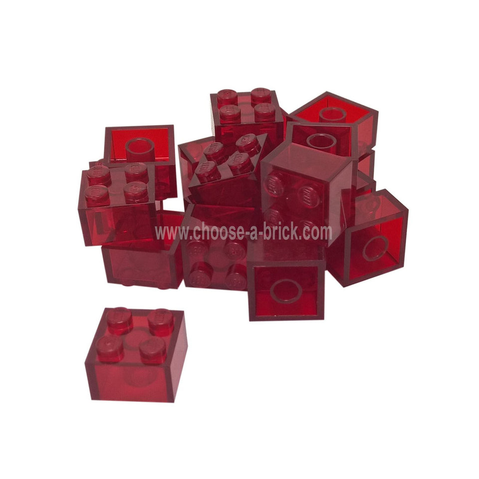 Pile of Trans-Red LEGO 2x2 bricks, angled view.