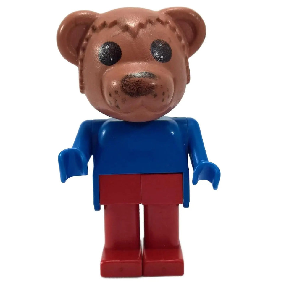 A LEGO® Fabuland Bernard Bear minifigure with a brown bear head, a blue torso and arms, yellow hands, and red legs, standing against a white background.