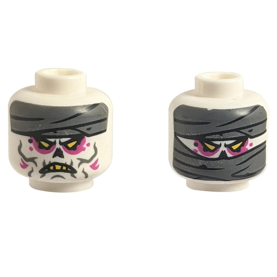 Dual-sided LEGO head 3626pb3445 with mummy wrappings and alien scowl.