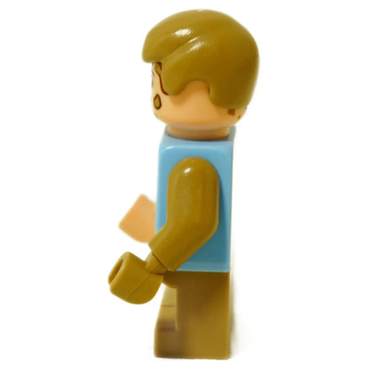 LEGO® minifigure Tim Murphy wearing a dirty blue shirt and tan legs, Jurassic Park character figure side profile view