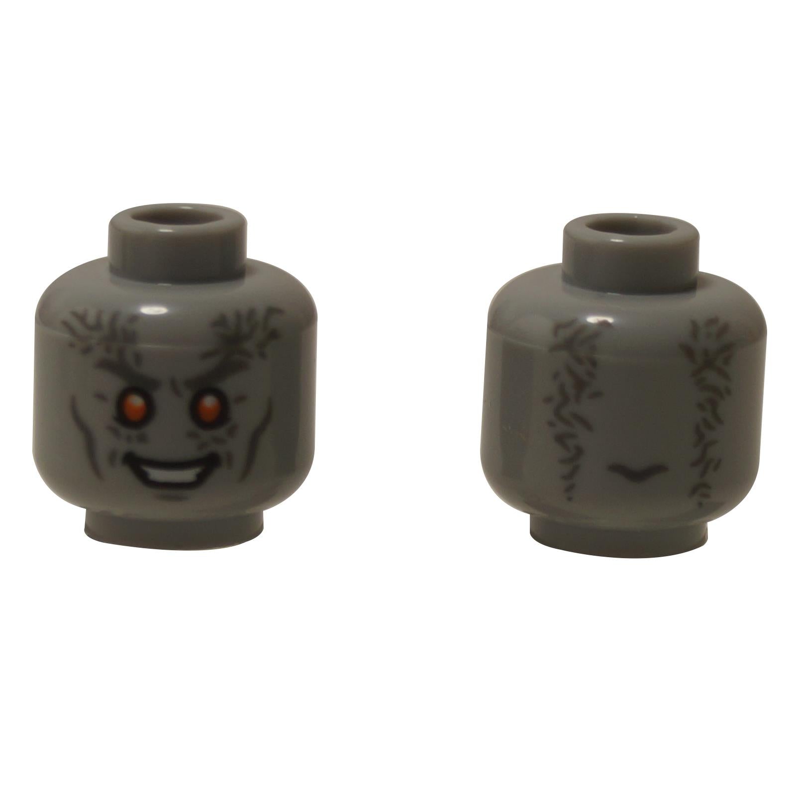 Front and alternate side views of the LEGO® alien minifigure head (3626pb3018) in light bluish gray, featuring glowing orange eyes, sharp white teeth, and dark wrinkle details extending around the sides.