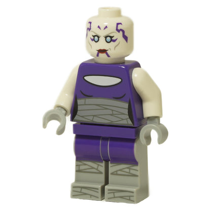 A LEGO® Star Wars™ minifigure of Asajj Ventress with a light nougat head featuring purple facial markings, sand blue eyes, and red lips, a dark purple torso with grey wrap printing and light flesh arms with light grey hands, and dark purple legs with grey wrap printing, standing against a white background.