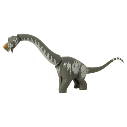 Full side profile of the dark grey LEGO Titanosaurus dinosaur figure with a long, striped tail.