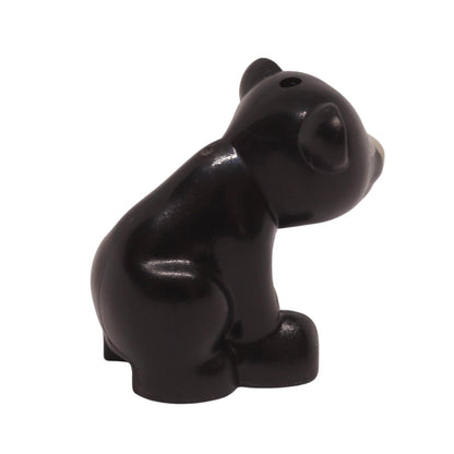 back view of LEGO black baby bear cub figure in a sitting pose with a tan muzzle and nougat eyes (Part 14732pb05).
