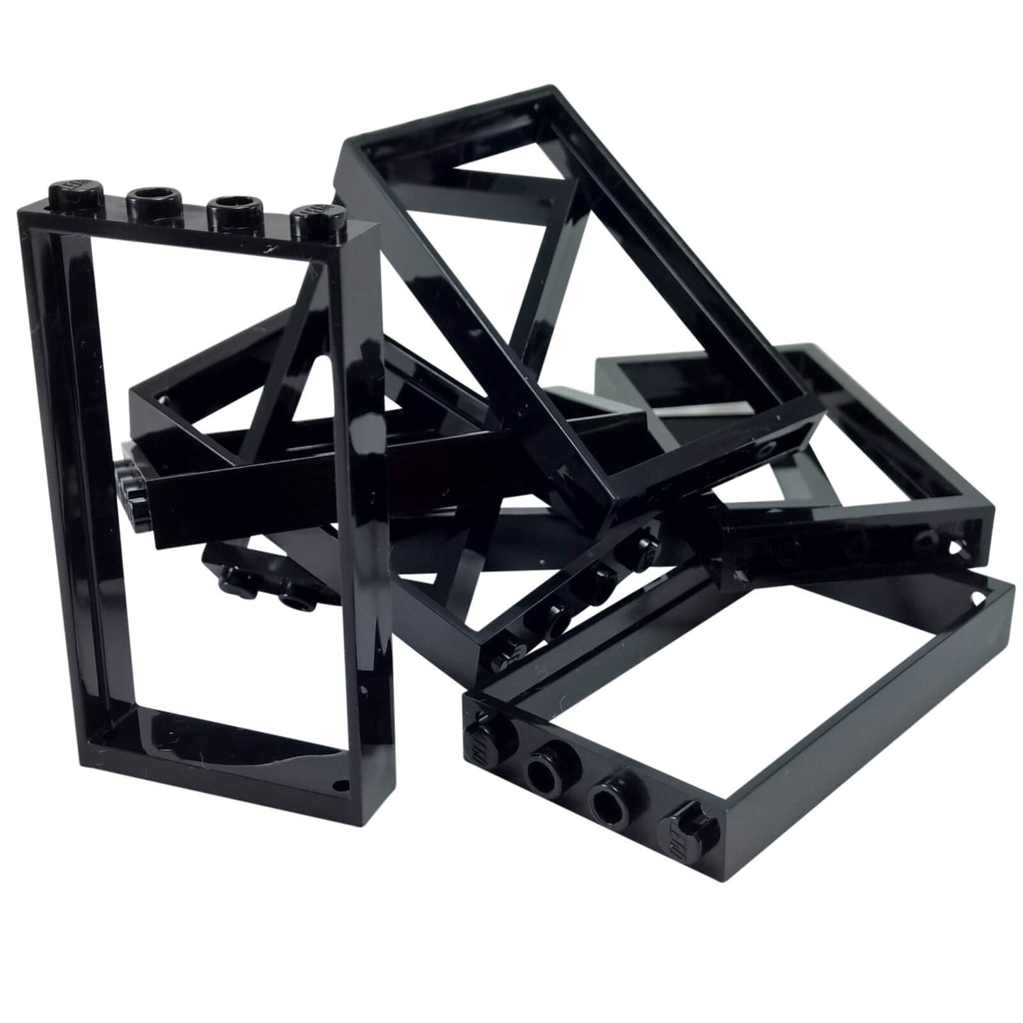 Pile of black LEGO Door Frame 1x4x6 Type 2 pieces (60596) showing studded tops and open construction.