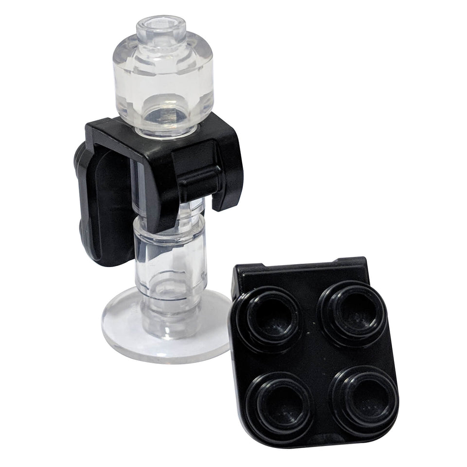 Black minifigure neck bracket with four back studs and front harness attachment, accessory connector for gear and packs
``
