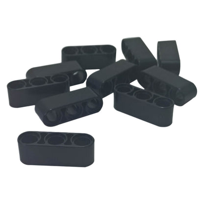 Pile of black LEGO Technic 1x3 Thick Liftarm pieces (32523) showing their holes.