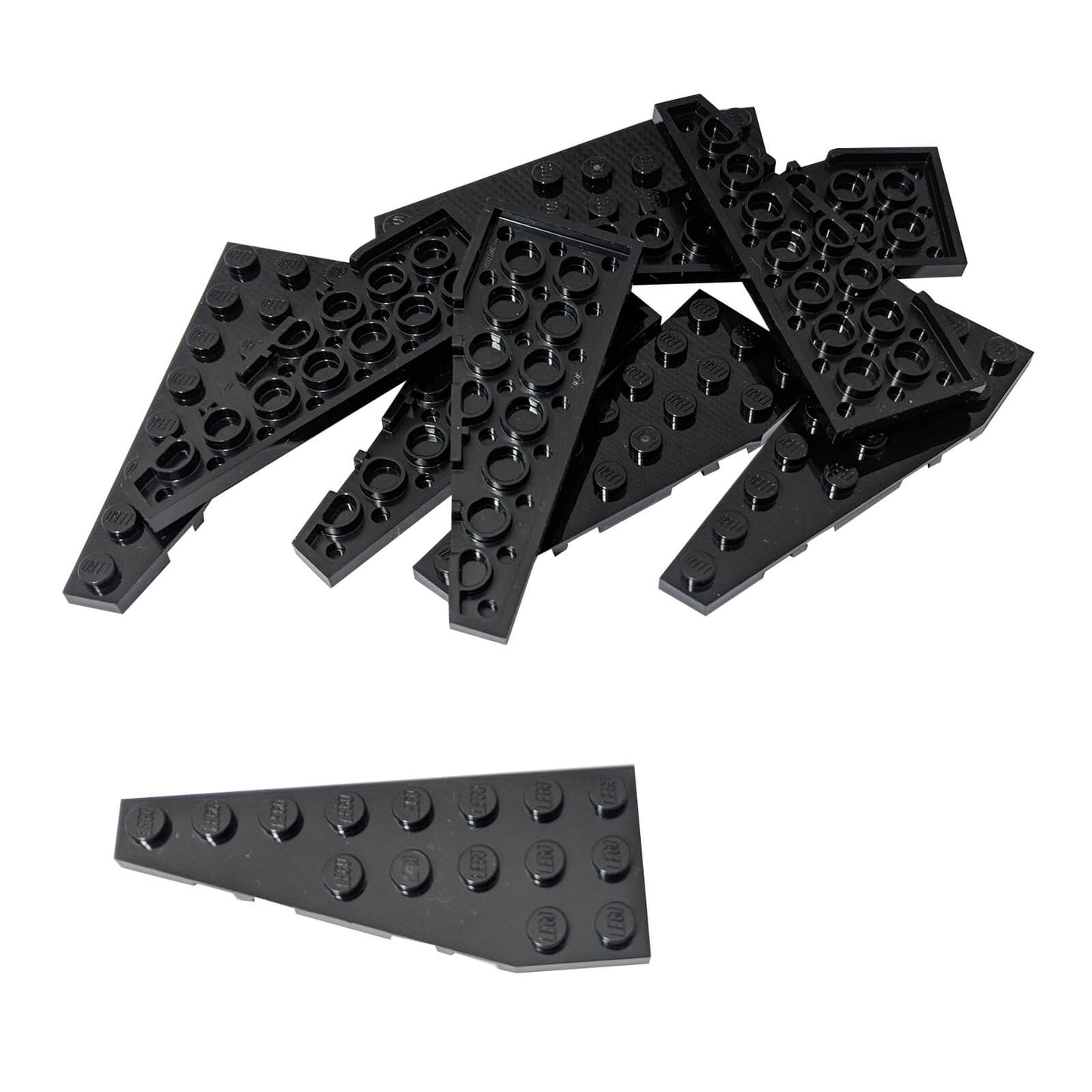 Pile of black LEGO Wedge Plate 8x3 Left pieces (50305) scattered on white background.