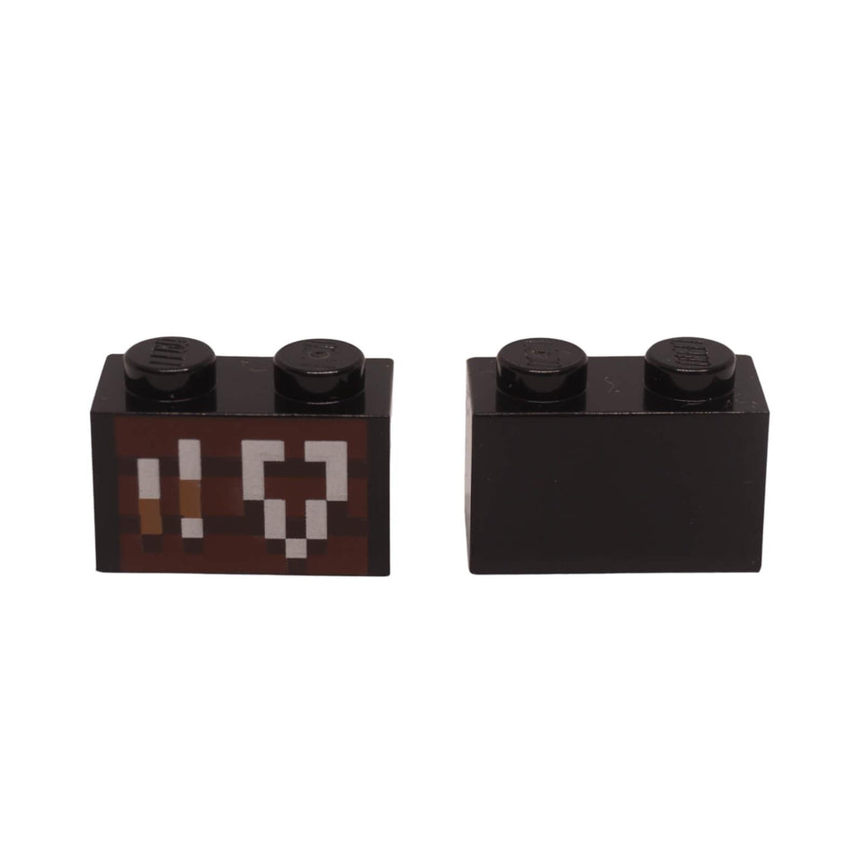 LEGO Minecraft 1x2 black brick with a printed smithing table pattern featuring pixelated tools.
