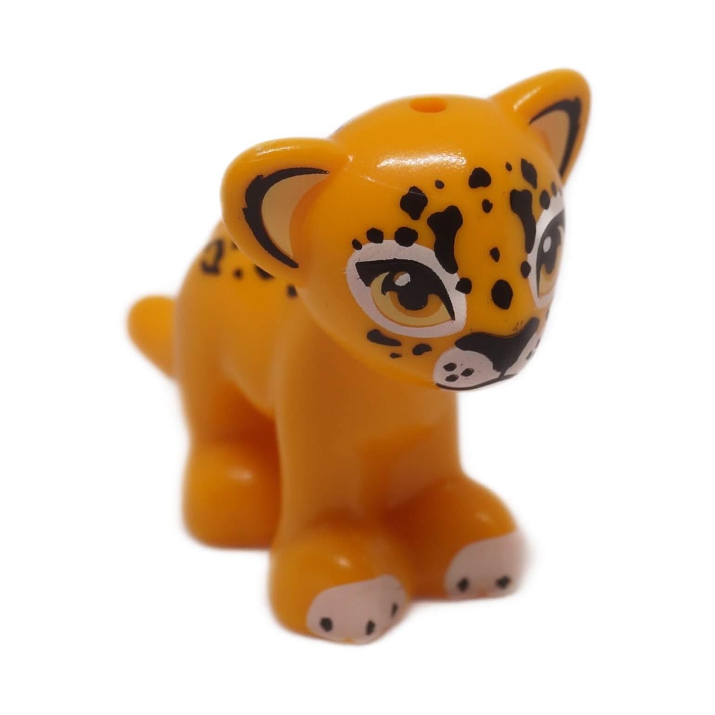 Bright light orange jaguar cub with black rosettes and large eyes, front left view animal figure
