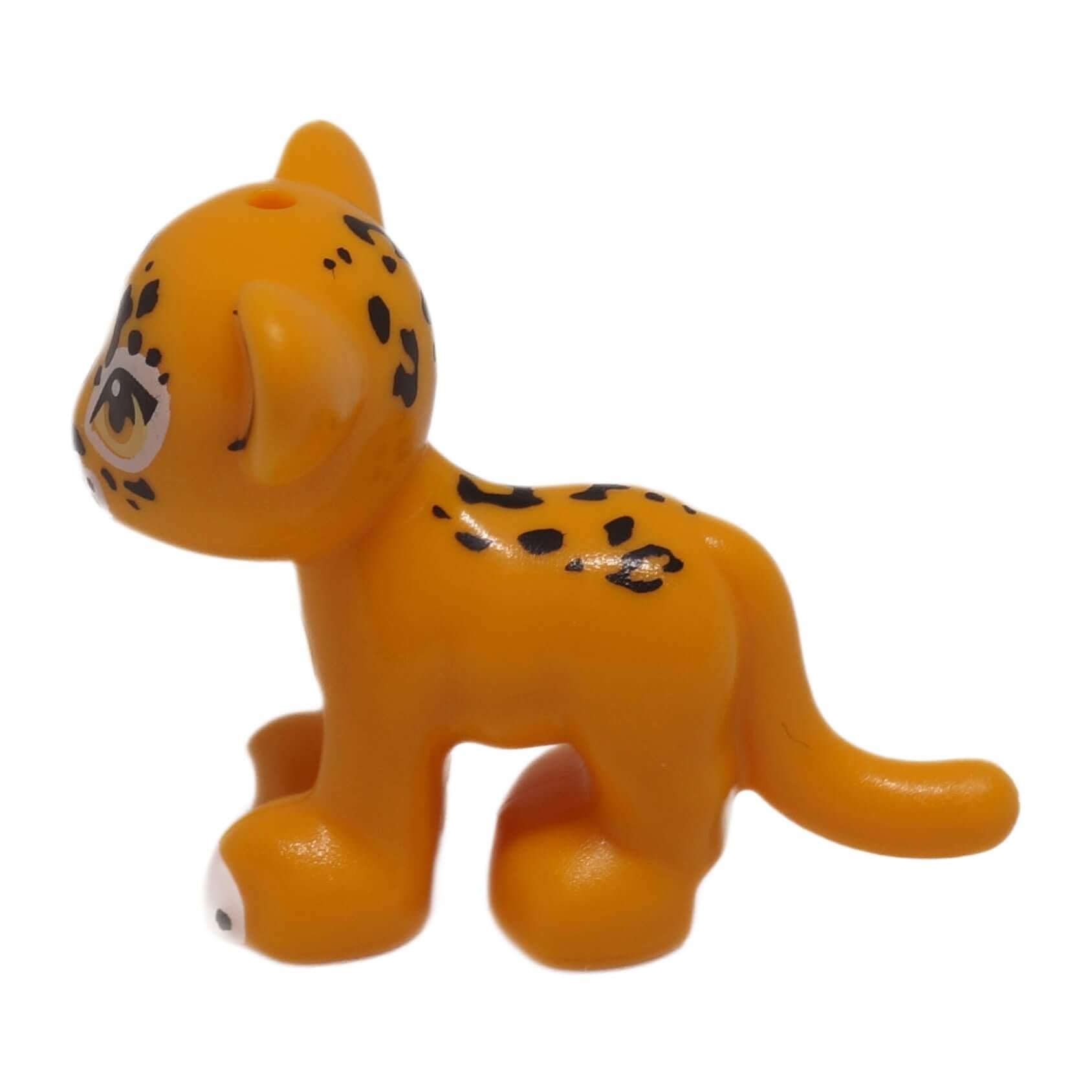 Bright light orange jaguar cub with black rosettes, right side profile small animal figure
