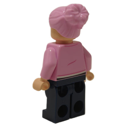 Back view of Brooklynn minifigure with pink hair bun and pink jacket, dark blue legs

