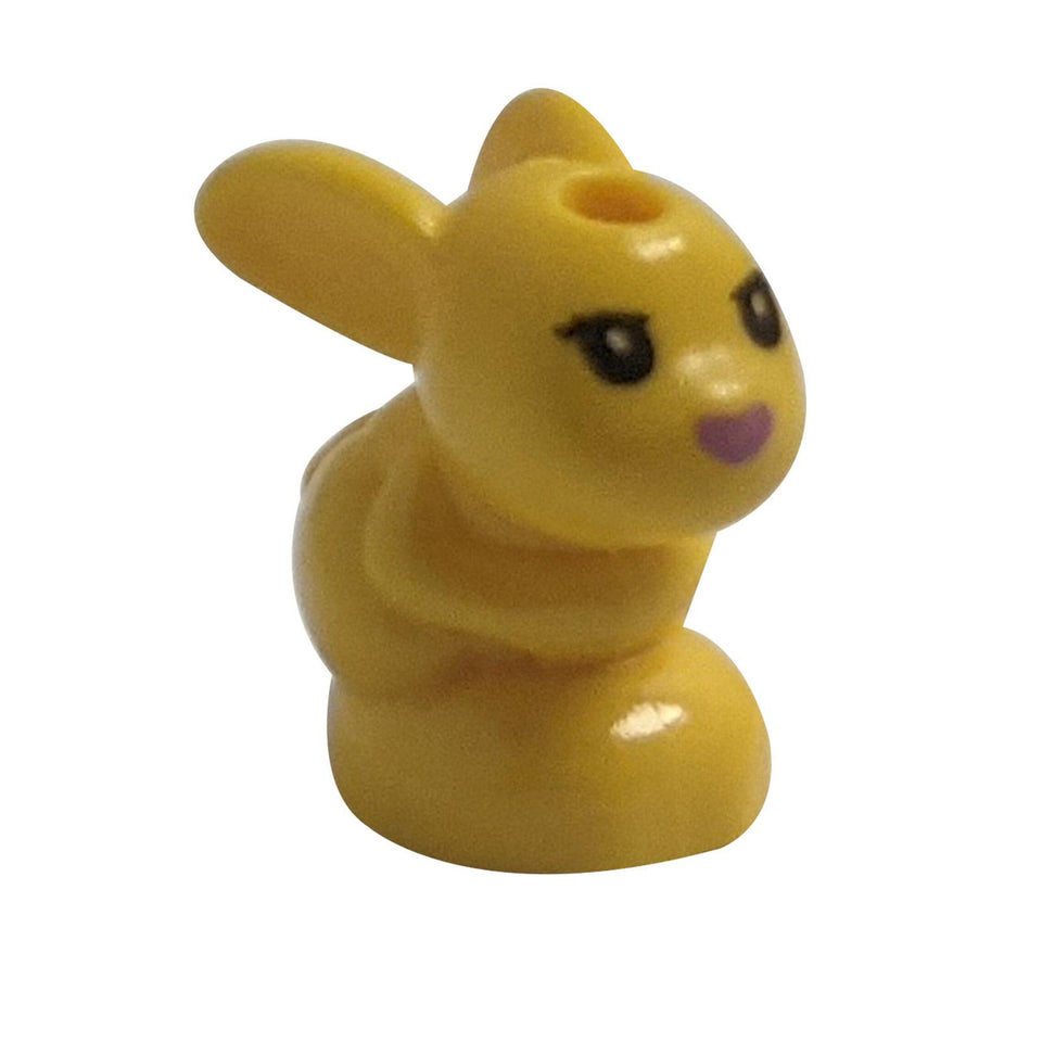 LEGO® yellow baby bunny figure in sitting pose with black eyes and purple nose – part 18852pb03 from LEGO® Friends.