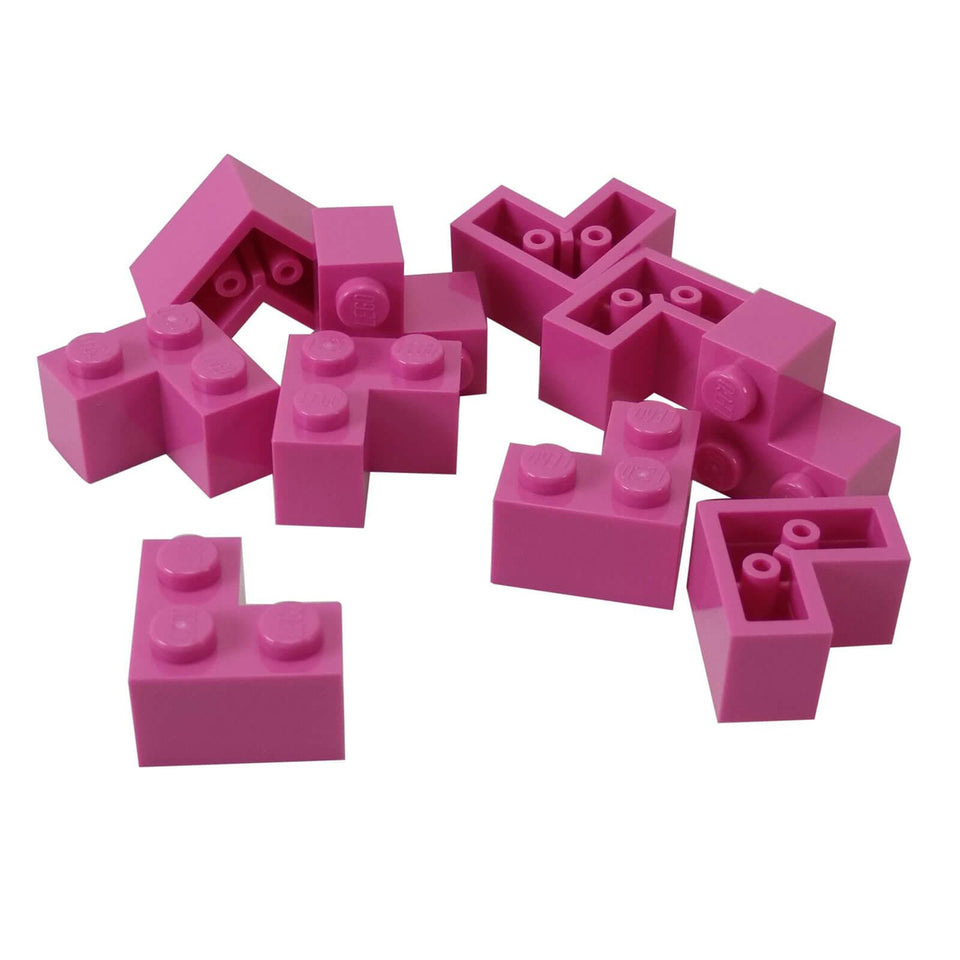 Multiple pink LEGO Brick 2 x 2 Corner pieces scattered.